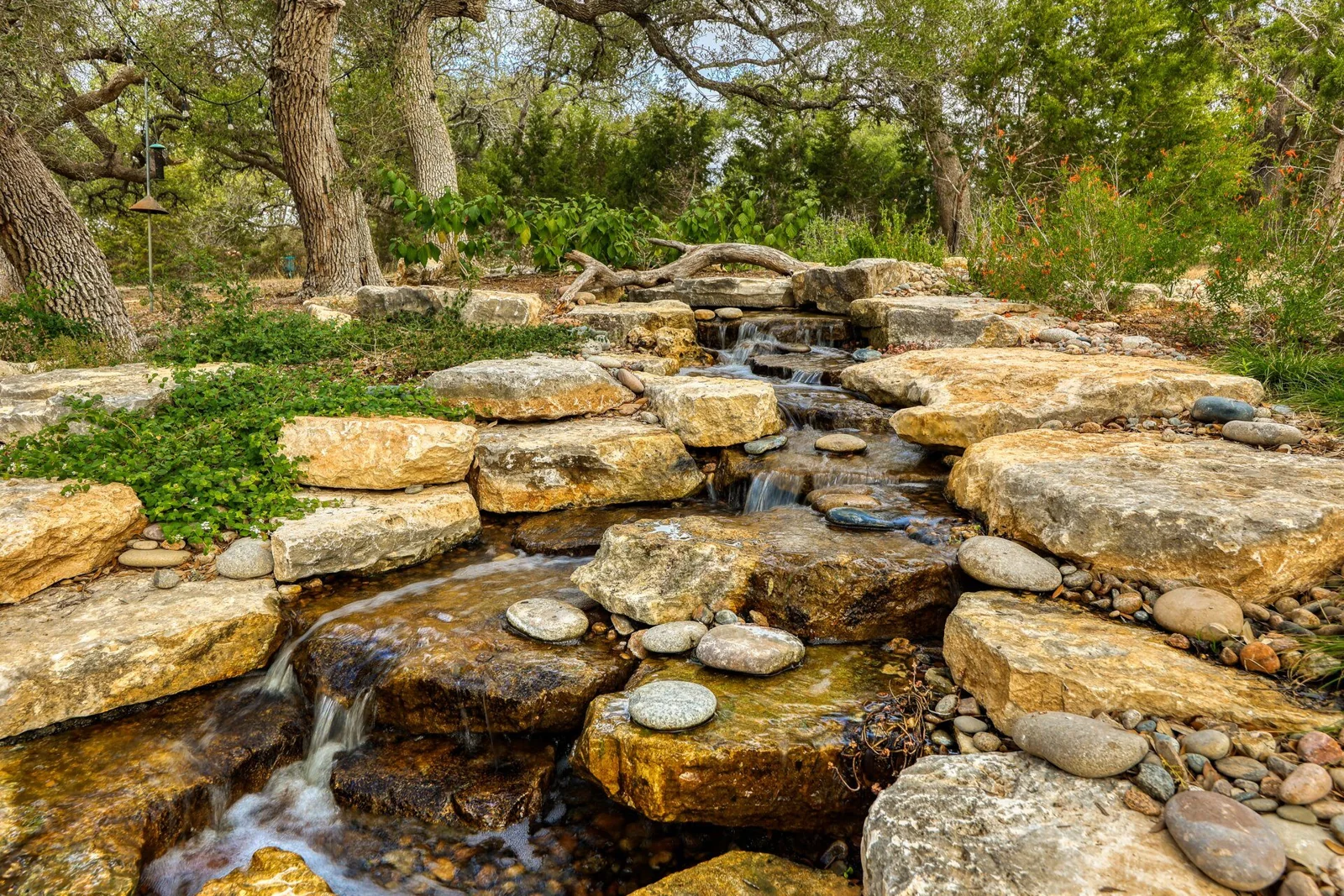 An award-winning limestone pondless waterfall