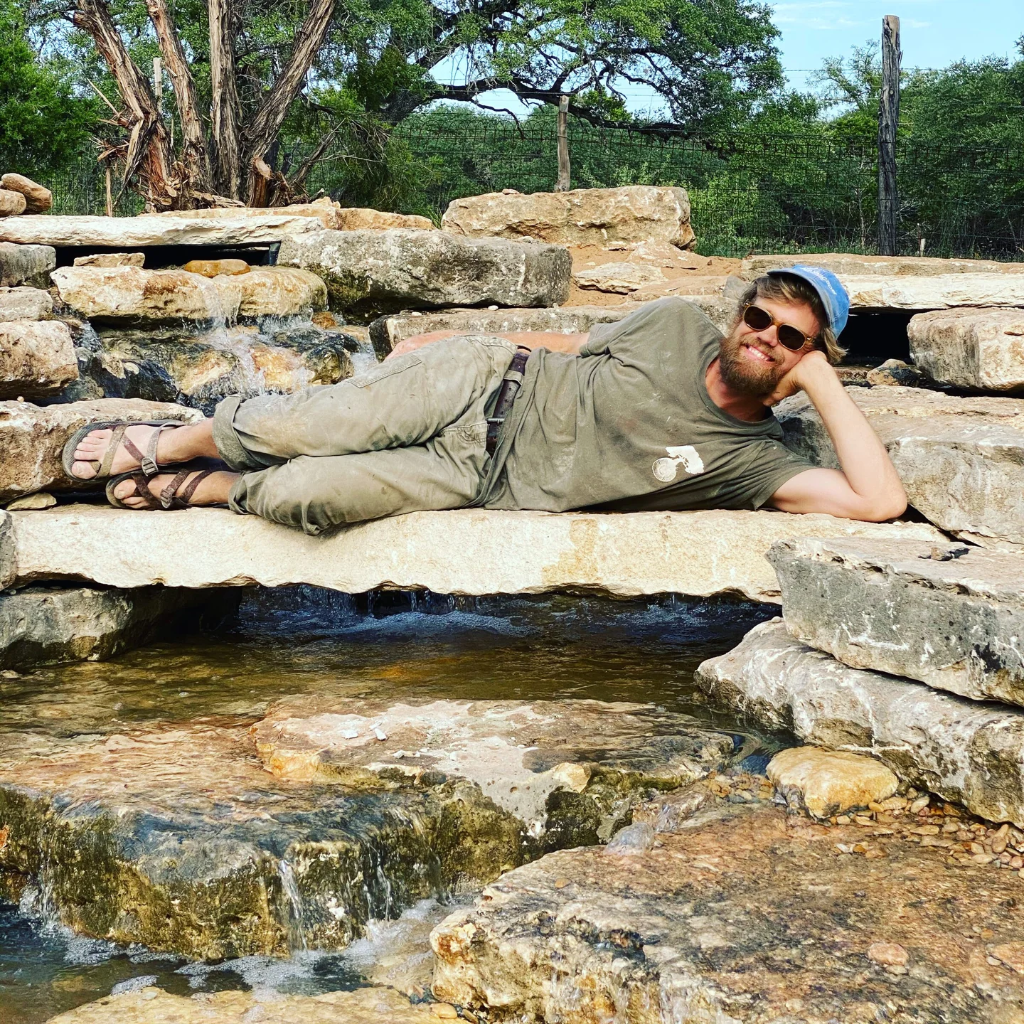 A Stonebridge craftsman resting on a finished limestone waterfall