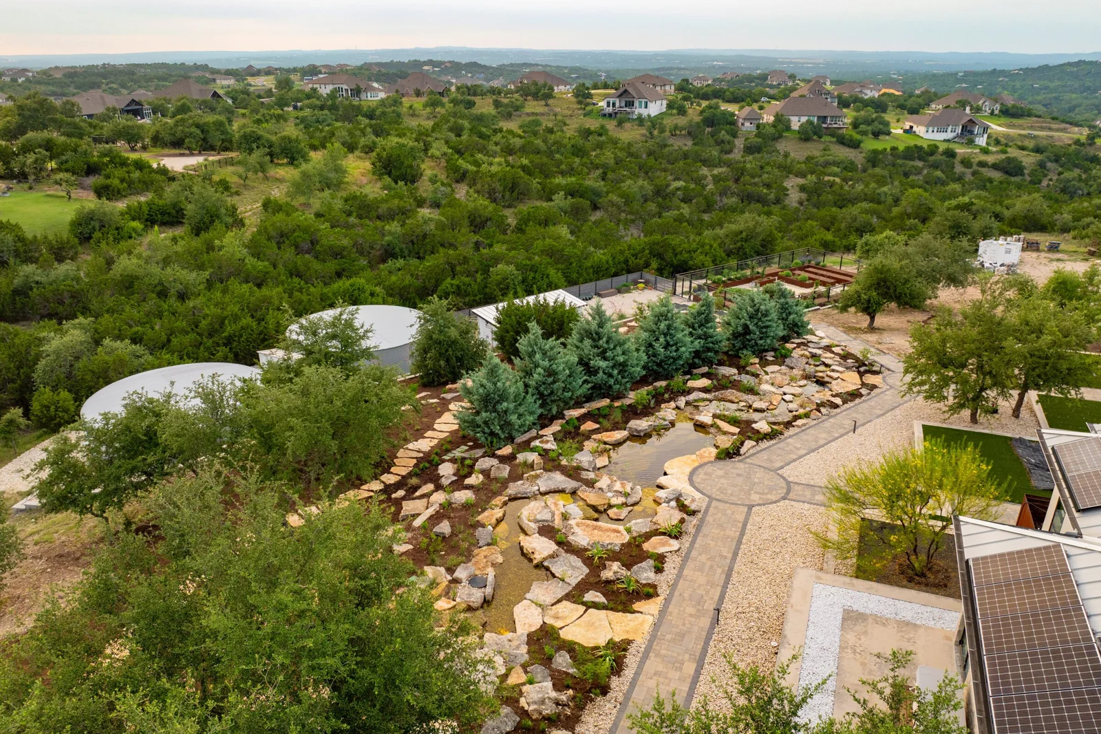 An aerial view of a Stonebridge stream and waterfall set into the Texas Hill Country
