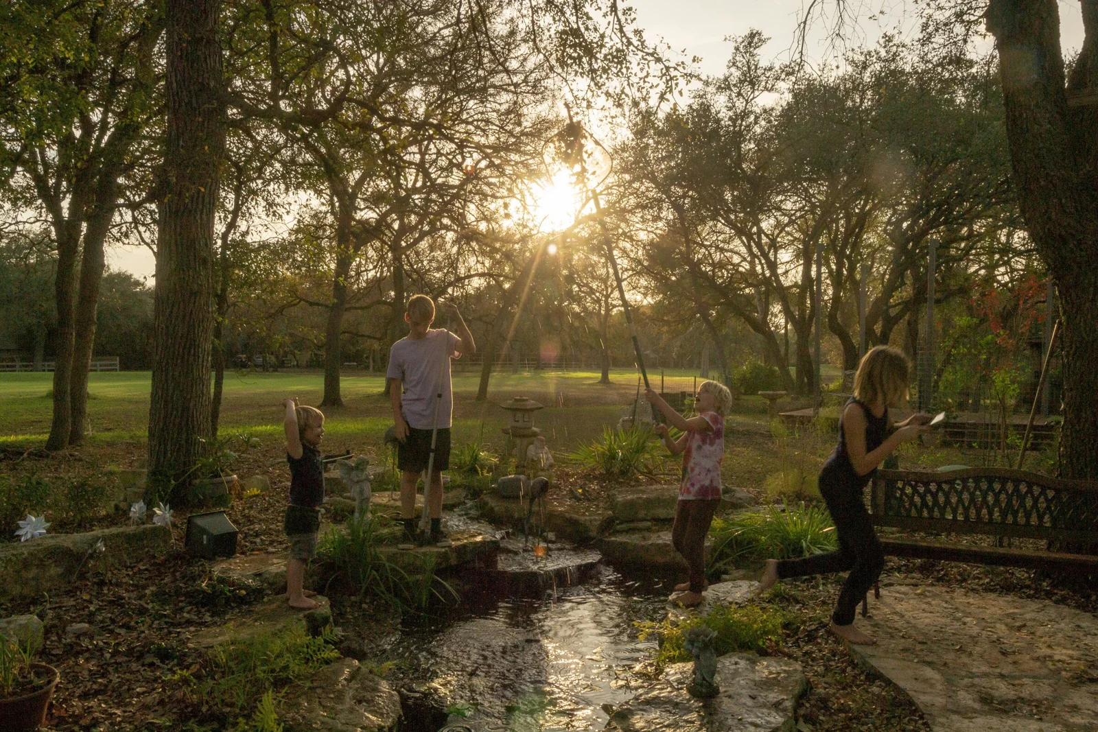 A family gathered at the edge of a finished pond