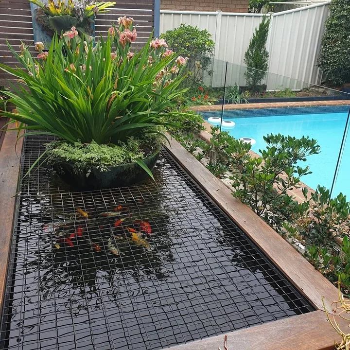 A planted spillway bowl spilling water into a rectangular garden basin