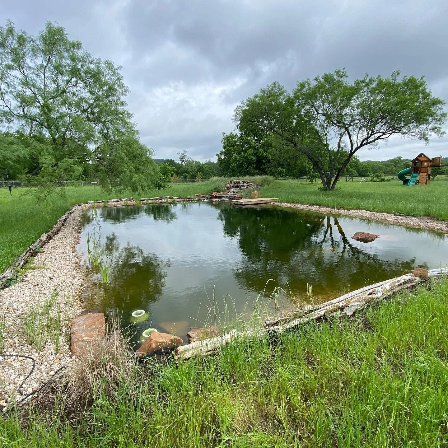 The site before construction of a 30 by 60 foot swim pond