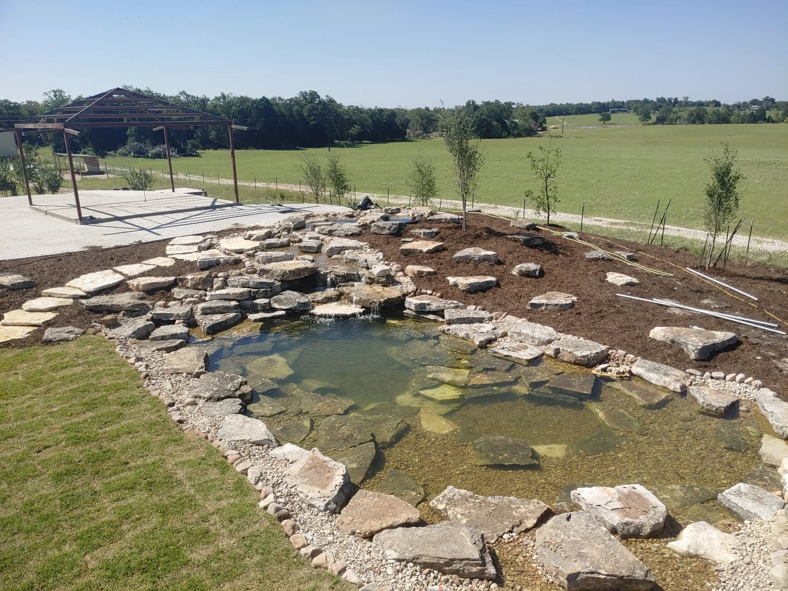 A limestone swim pond with open Hill Country views